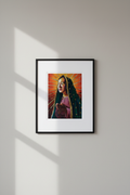 Nuestra Señora de Guadalupe framed fine art print — thin black frame with white mat on neutral grey wall